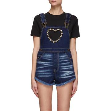 AREA 这款背带短裤将品牌标志性的仿水晶金属扣饰融入设计，将其化用为圆顶铆钉打造出心形镂空设计，为蓝色单品带来精致闪亮一笔，轻松打造你的吸睛时尚造型。